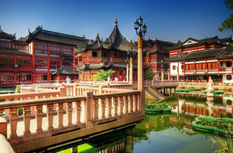 一栋建筑前的一个小池塘上有一座桥